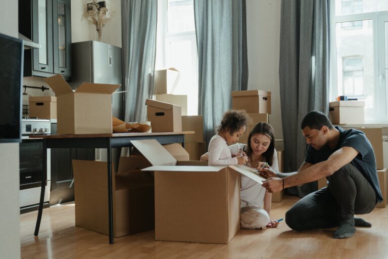 Family unpacking boxes inside home